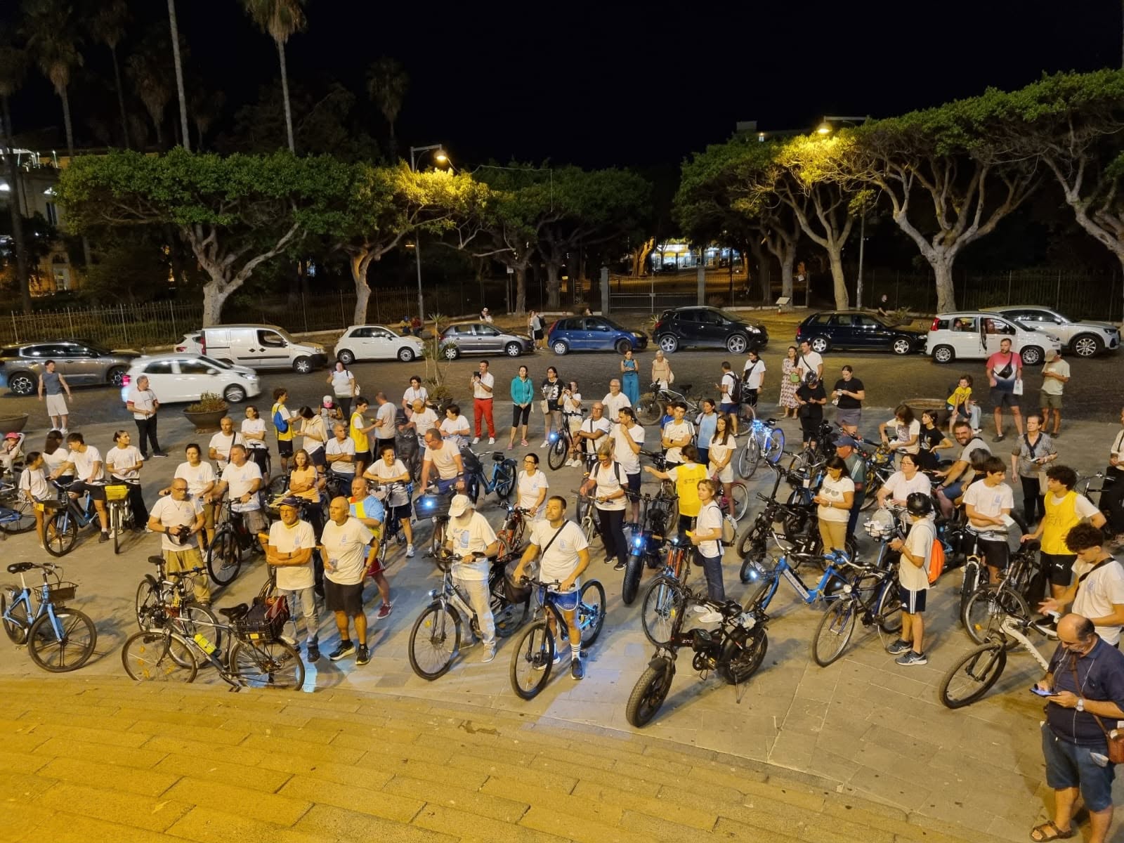 Families and enthusiasts riding bicycles through sun-drenched city streets